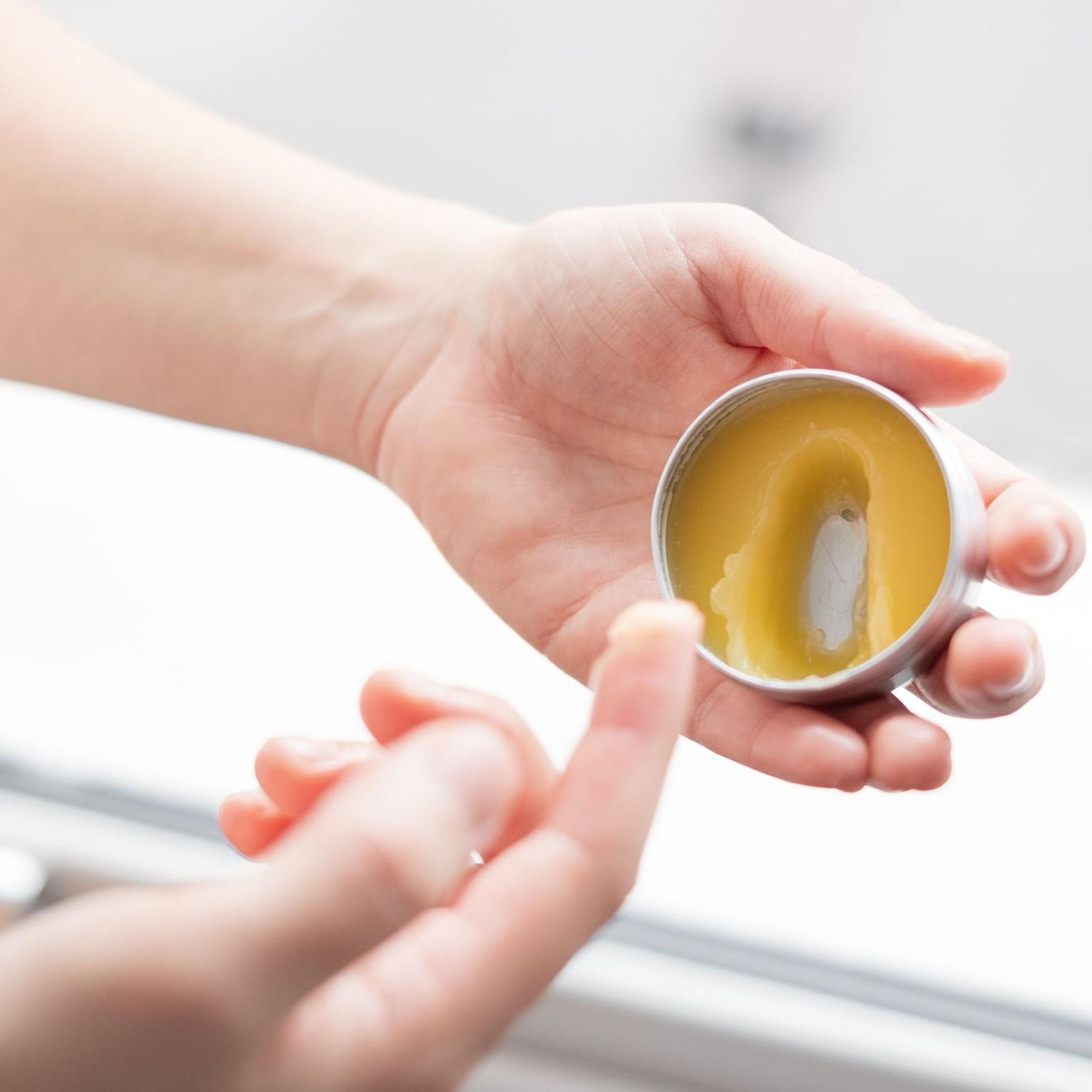 person holding yellow round ornament